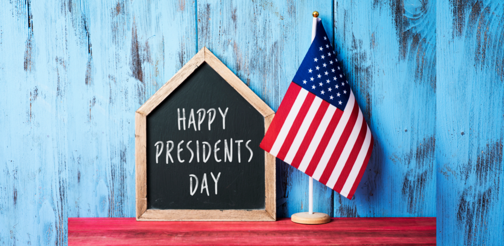 Chalkboard house with Happy Presidents Day beside American Flag